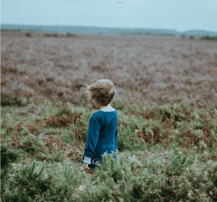 Child standing in a field